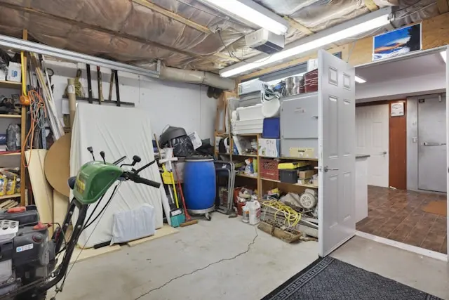 Cluttered garage before a cleanout — boxes, furniture, and years of accumulated junk